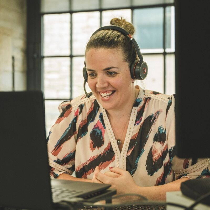 Kate speaking to a client on a headset